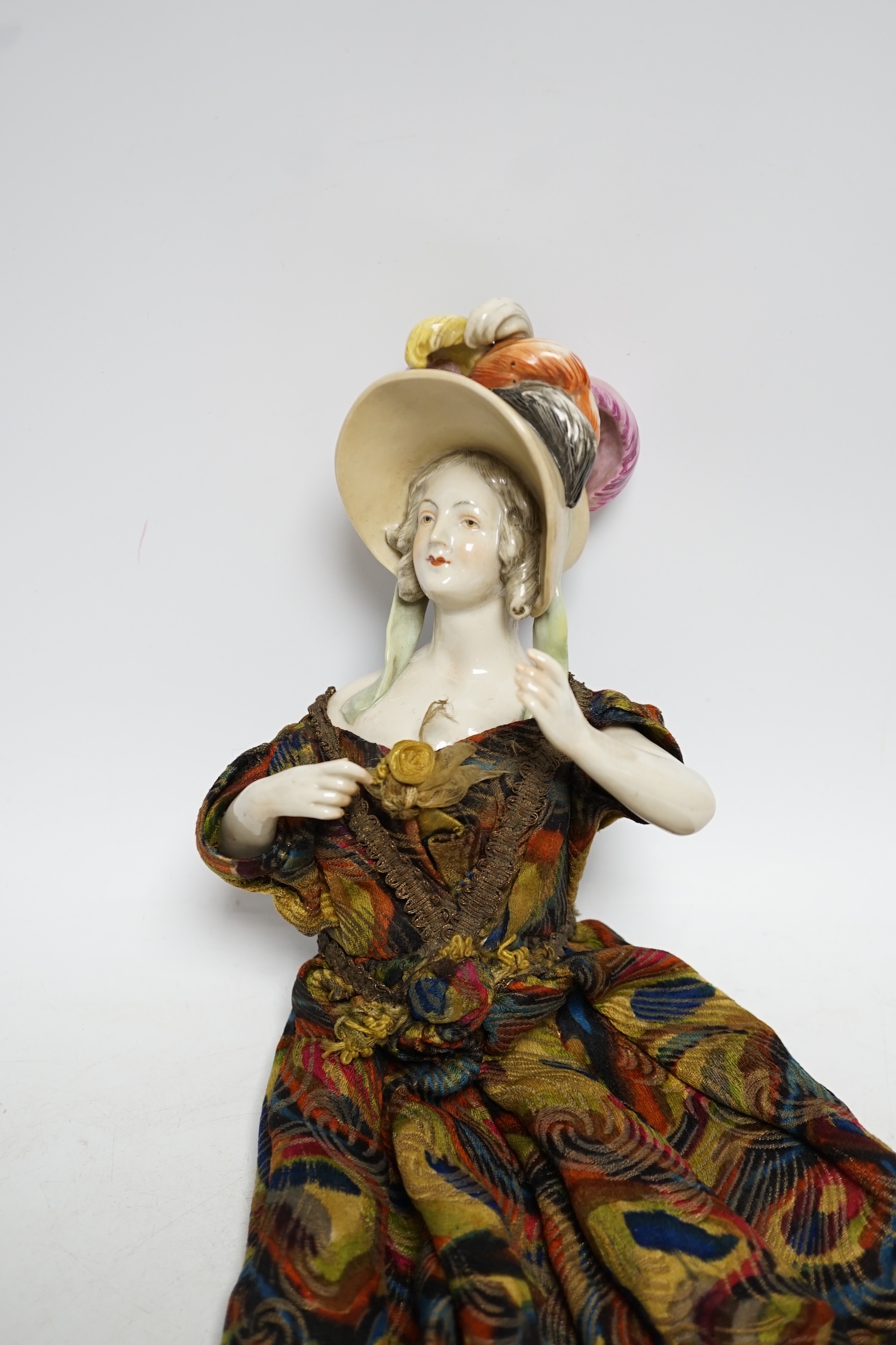 A 1920’s porcelain pin dolly, 18cm high not including dress. Condition - good